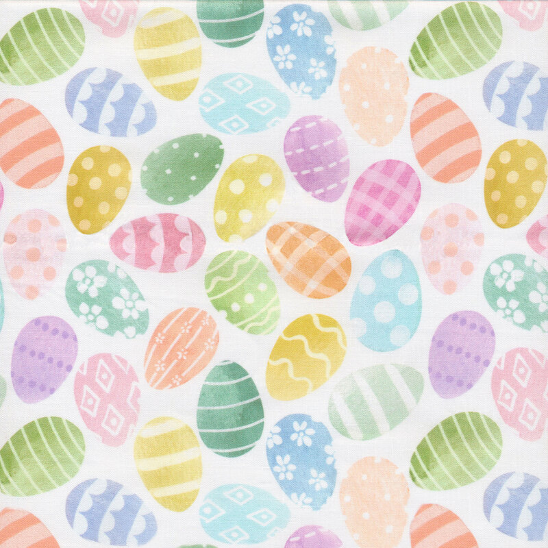 A solid white fabric covered in multi colored pastel Easter eggs