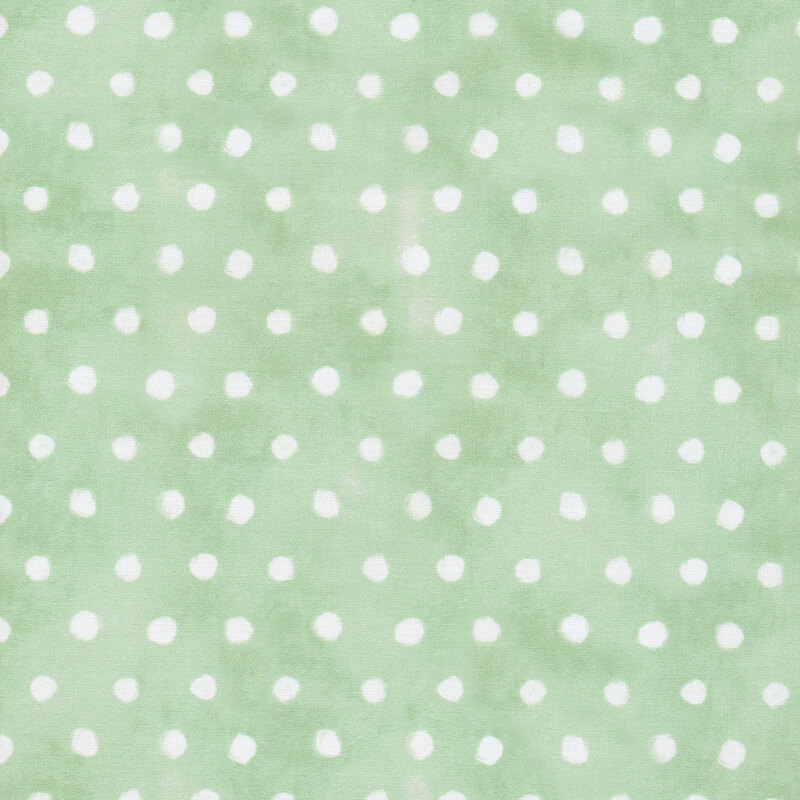 Light green pastel fabric with small white polka dots