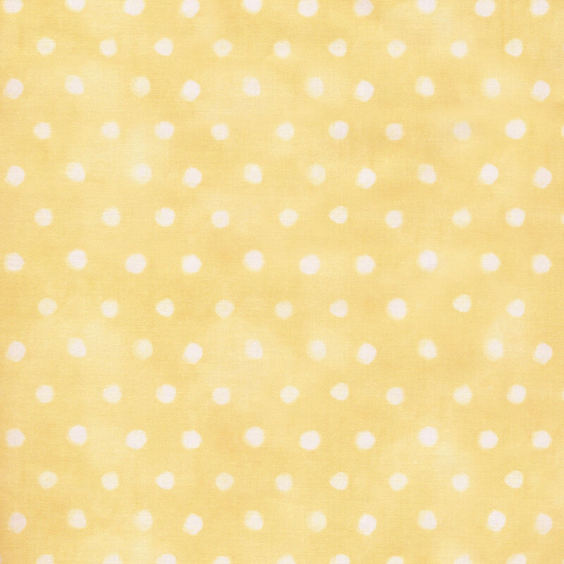 Light yellow pastel fabric with small white polka dots