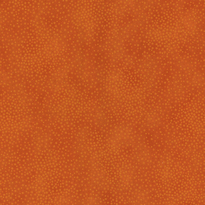 Tonal burnt orange fabric with meandering dots and spots all over a mottled background