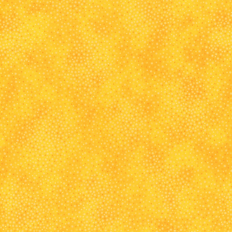 Bright yellow fabric with meandering dots and spots all over a mottled background