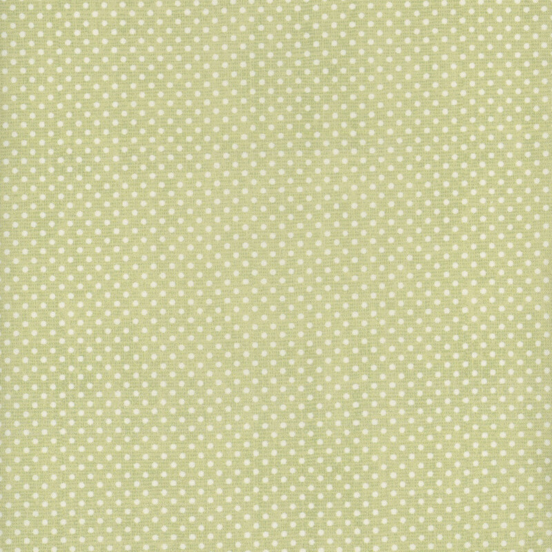 A spring green fabric with small white polka dots all over