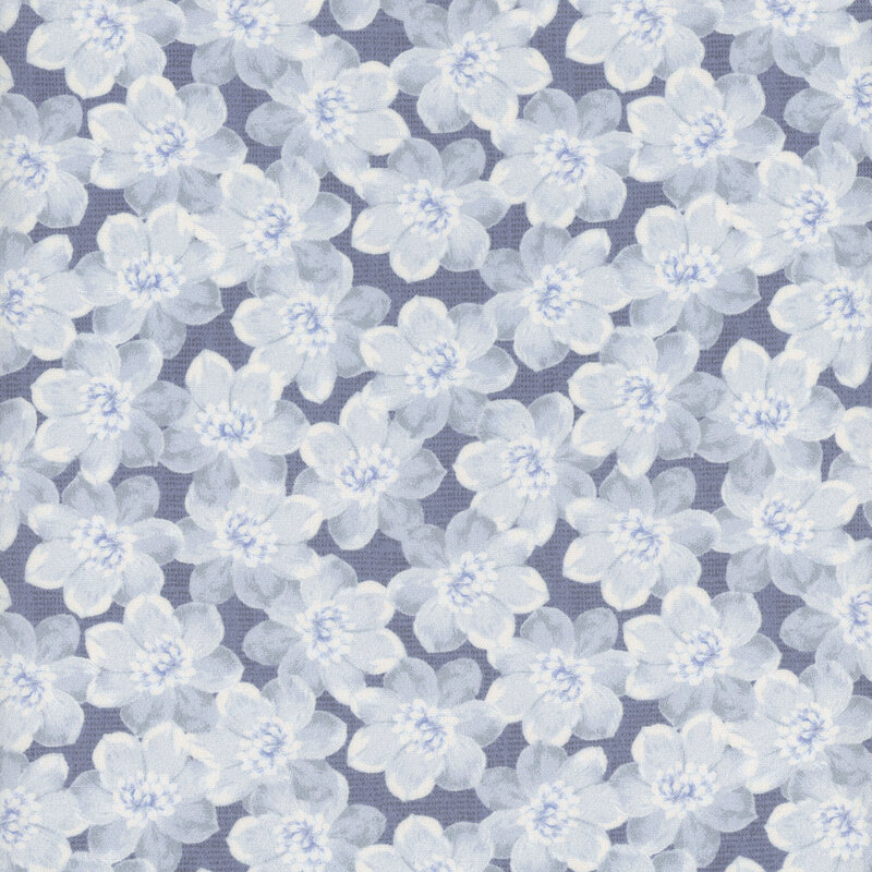 A blue gray textured fabric with packed pale blue florals all over