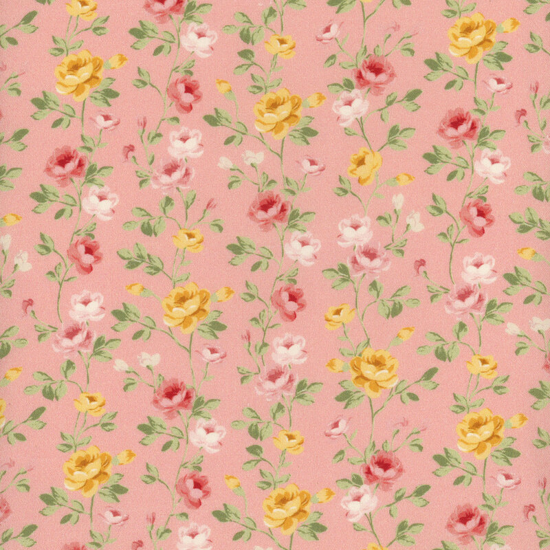 A medium pink fabric with green vines full of red, yellow, and pale pink roses.
