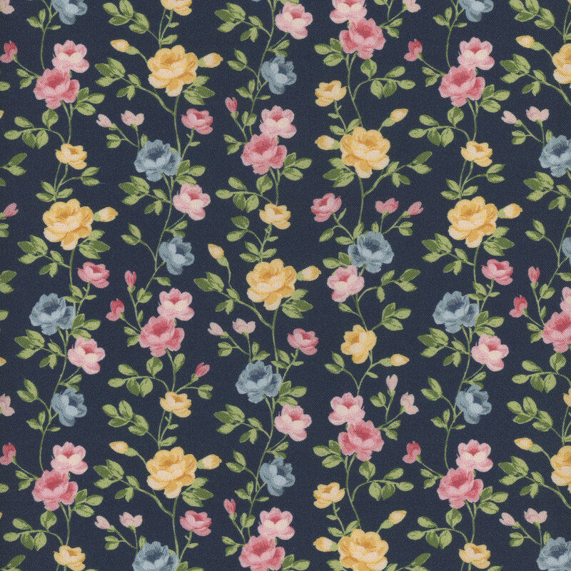 A navy blue fabric with green vines full of bright yellow, pink, and pale blue roses.