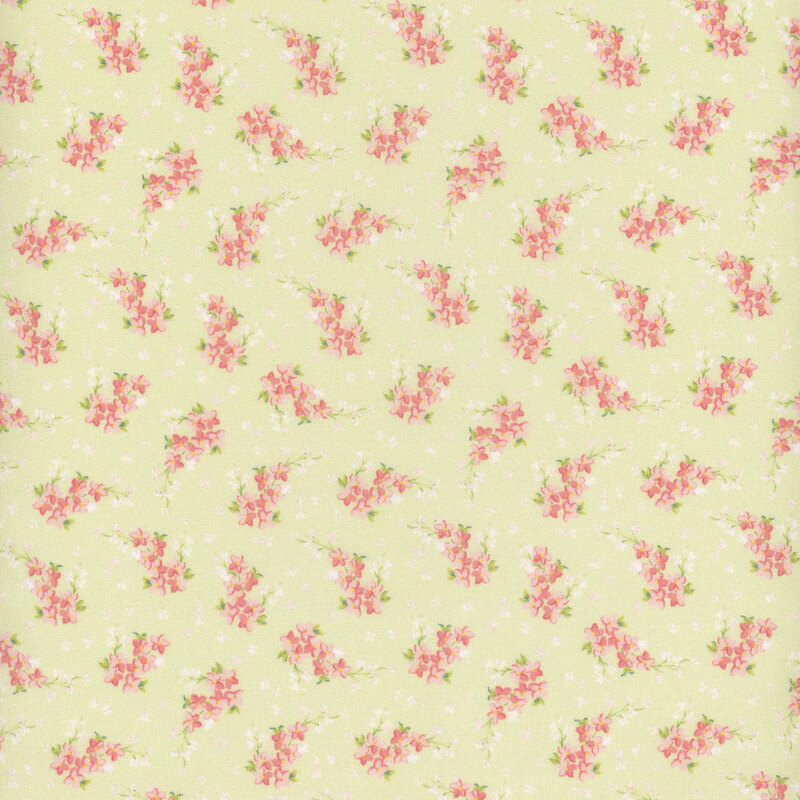 Green fabric with small white flower petals all over and ditsy clusters of pink flowers