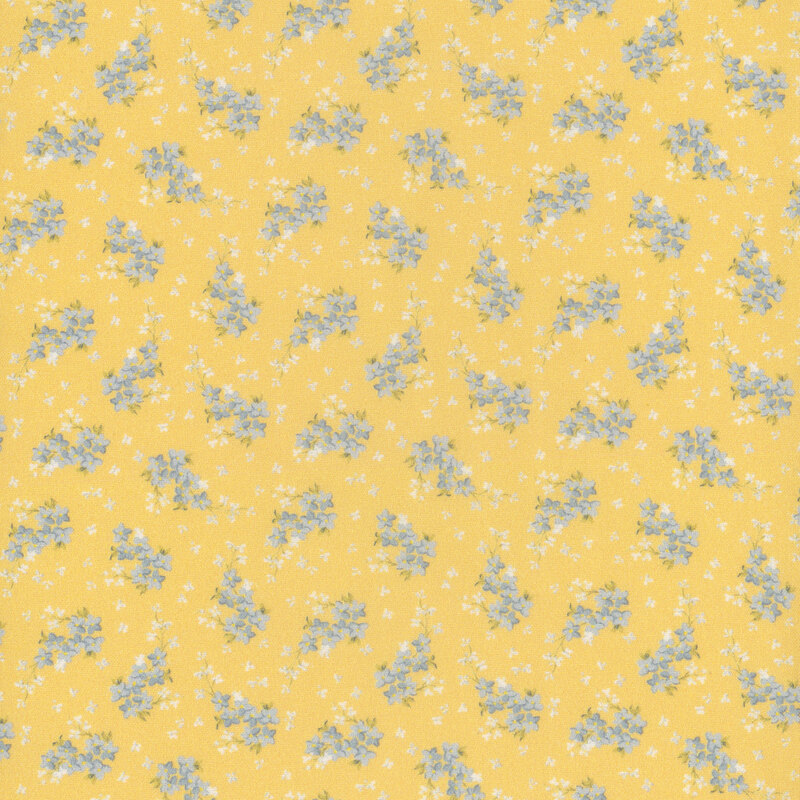 Yellow fabric with small white flower petals all over and ditsy clusters of blue flowers