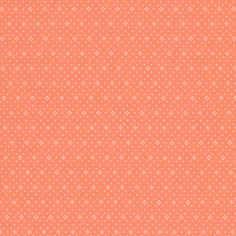 Light coral fabric with small white dots all over