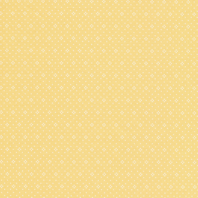 Light yellow fabric with small white dots all over