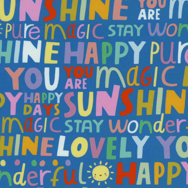 Children's fabric with large children's phrases and small smiling suns agains a blue background