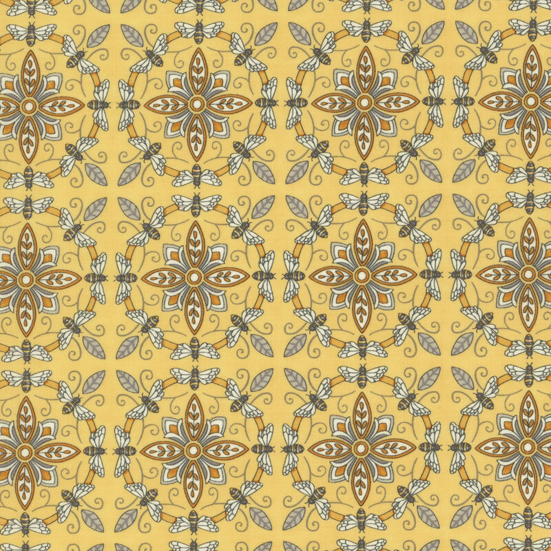 yellow fabric with ornate yellow and grey tiles made from bees and flowers