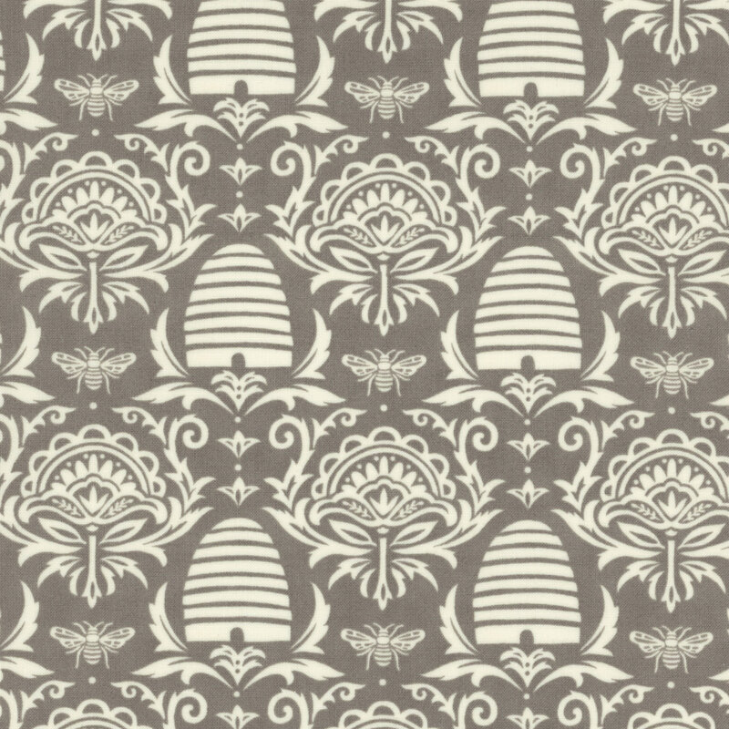 tonal grey fabric with damask, beehive, and honey bee designs on it