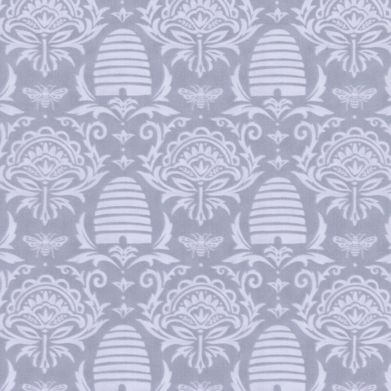 tonal lavender fabric with damask, beehive, and honey bee designs on it