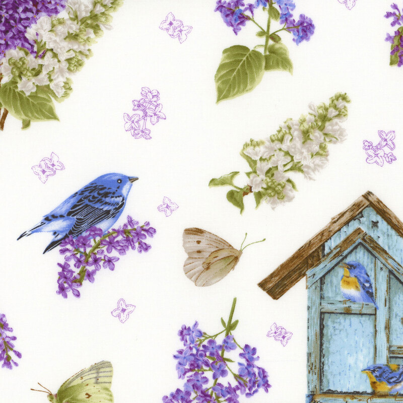 fabric with scattered lilacs, butterflies, birdhouses, and baskets on a background of white