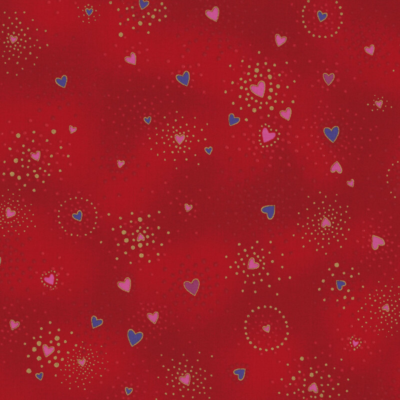 Red fabric with blue and purple hearts tossed all over with clustered gold metallic flecks and pink dots
