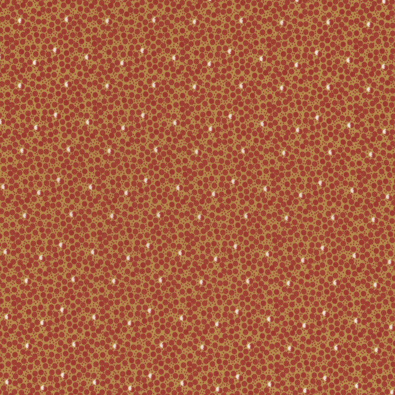 fabric featuring red and cream dots in a ditsy pattern on a tan background