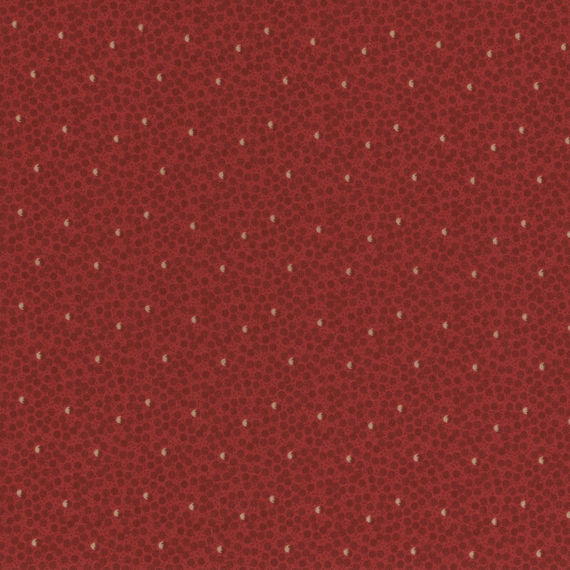 fabric featuring red and cream dots in a ditsy pattern on a bright red background