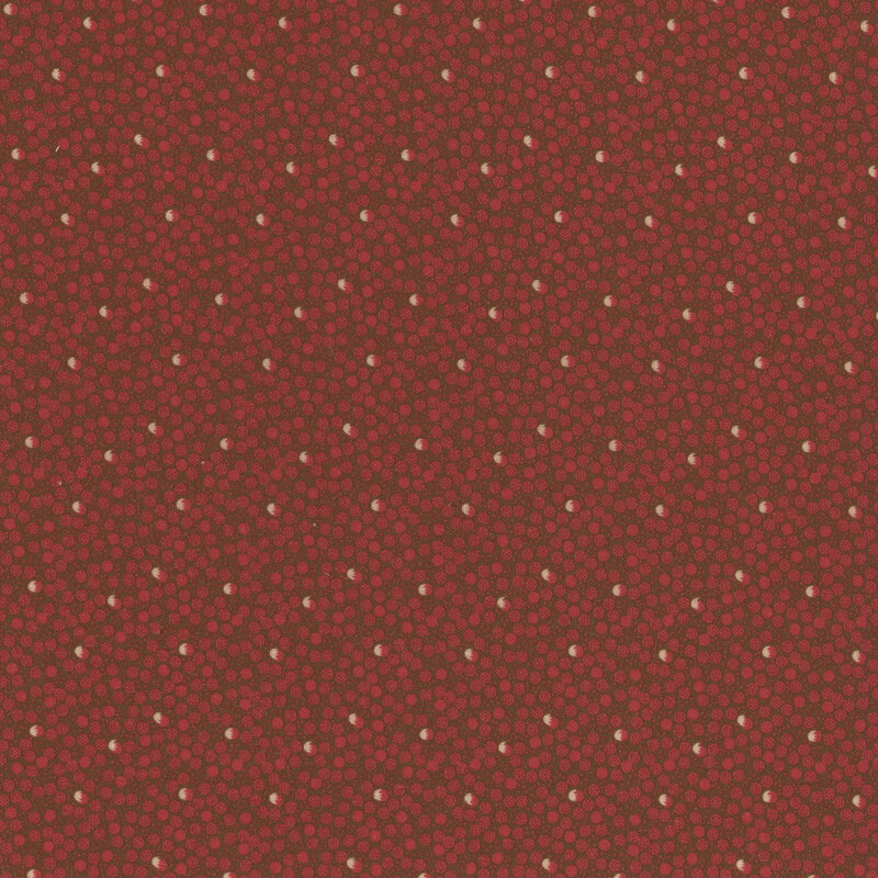 fabric featuring red and cream dots in a ditsy pattern on a dark green background