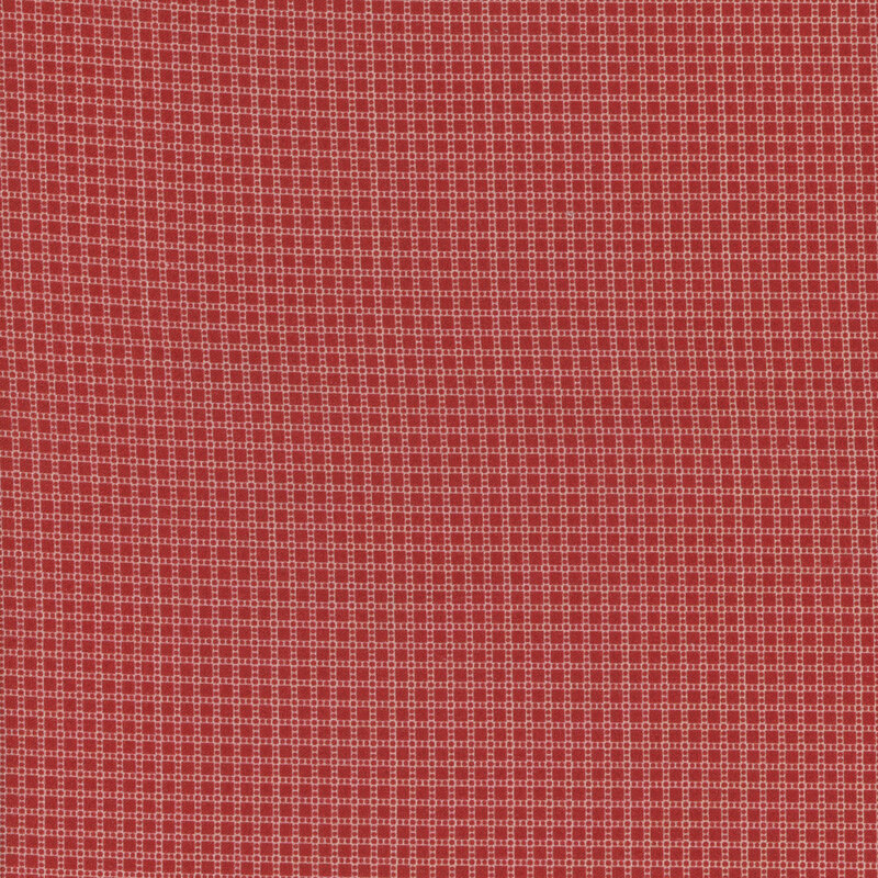 fabric featuring ditsy red squares and dots on a cream background