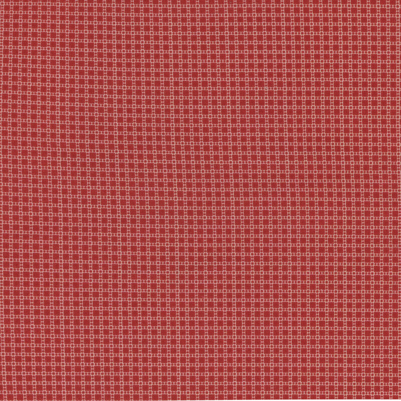 fabric featuring ditsy red squares and dots on a cream background
