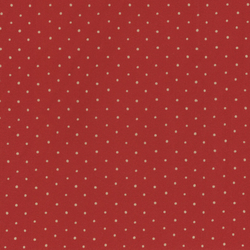 fabric featuring cream dots on a rich red background