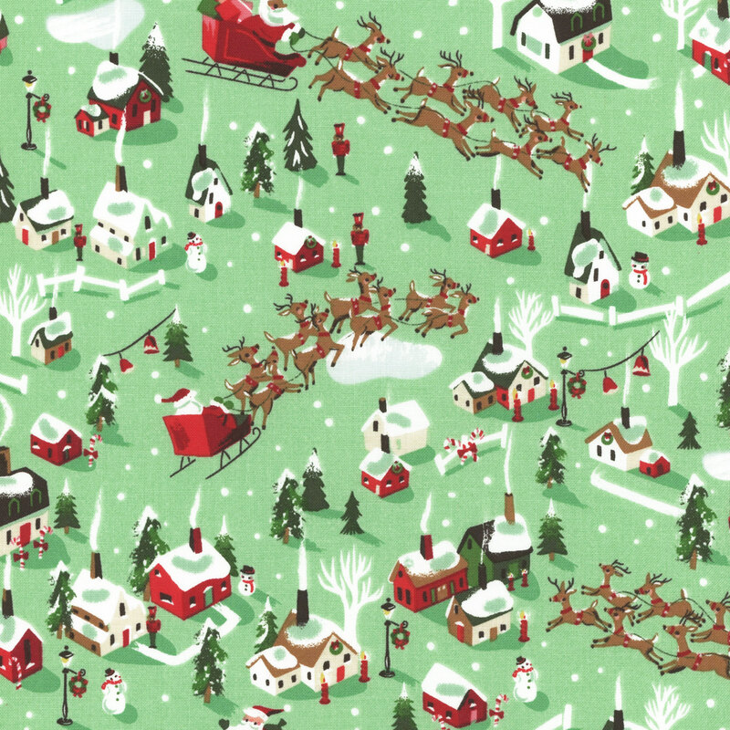 fabric featuring red, green and white houses with Santa and his reindeer soaring above on a mint green background.