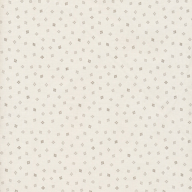 fabric with a cream background decorated with clusters of tiny brown dashes