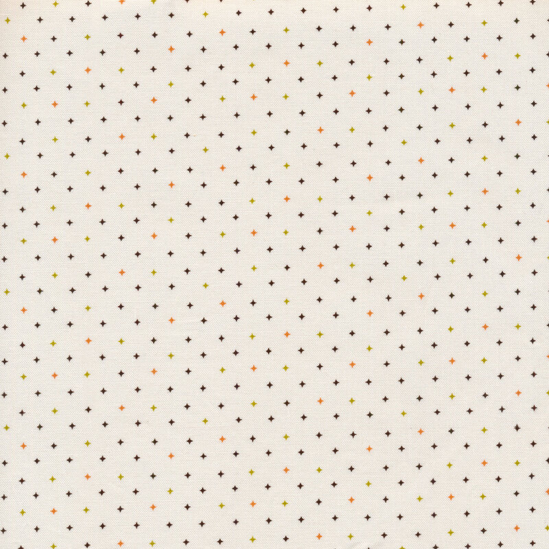 fabric with a cream background decorated with multicolor diamond stars