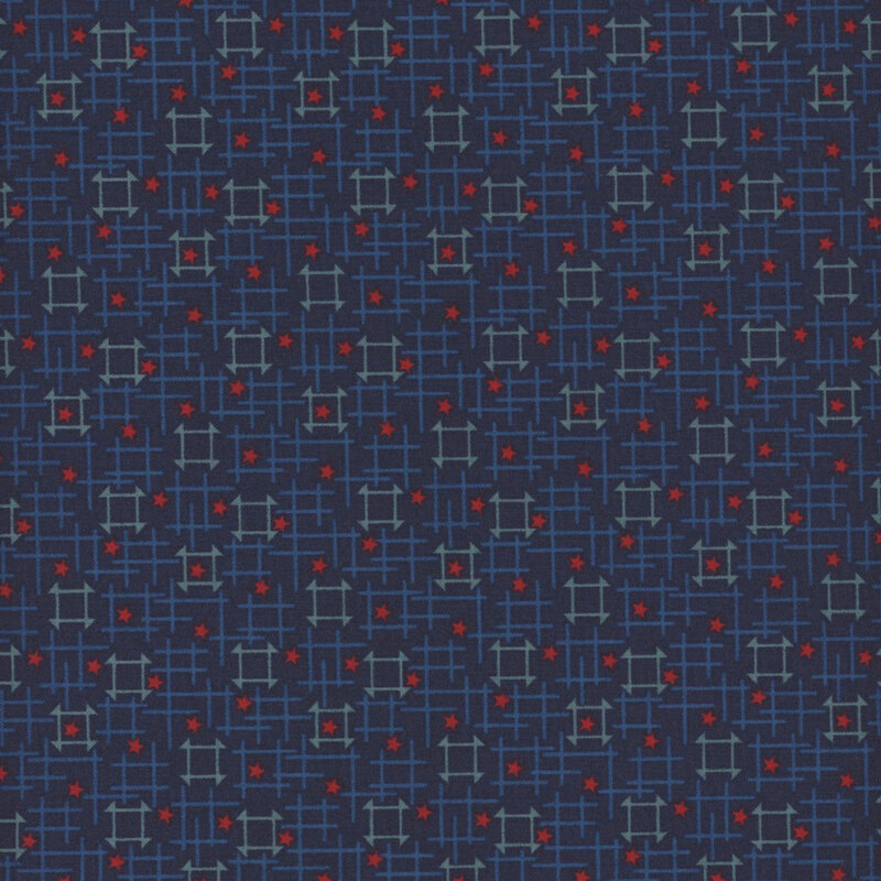 Fabric with tonal blue geometric squares with red stars on a navy blue background.