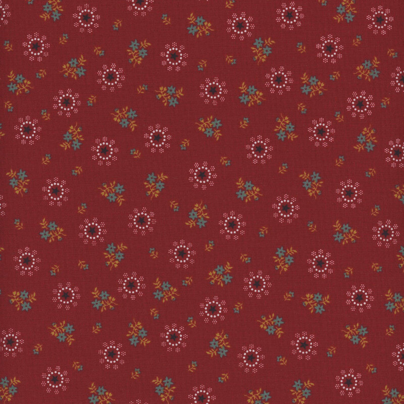 Fabric with star motifs in cream and blue with tan and blue floral clusters on a red background.