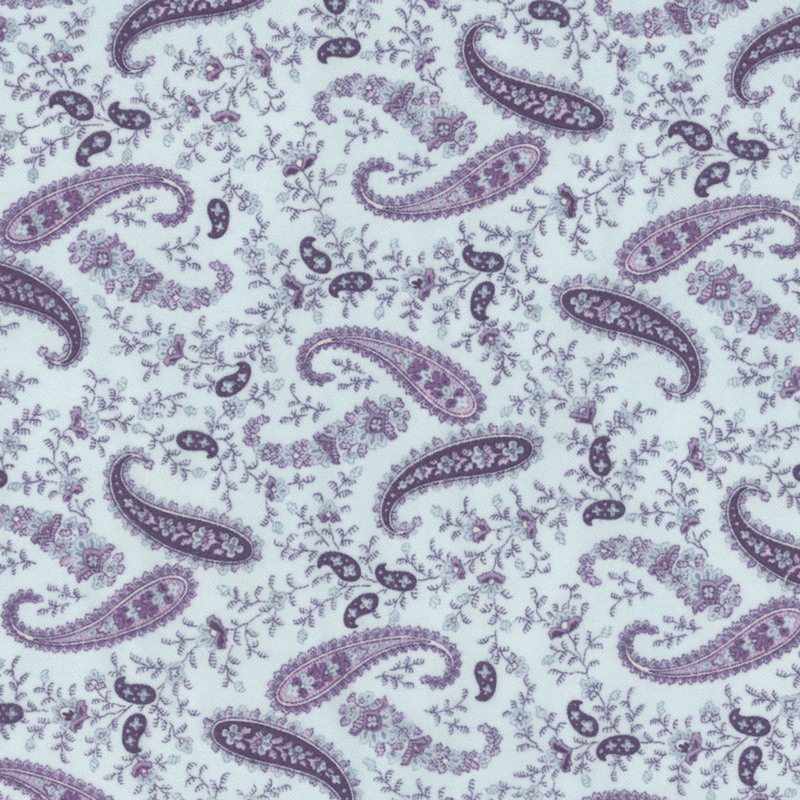 flannel fabric featuring a purple paisley print with small flowers on a light blue background