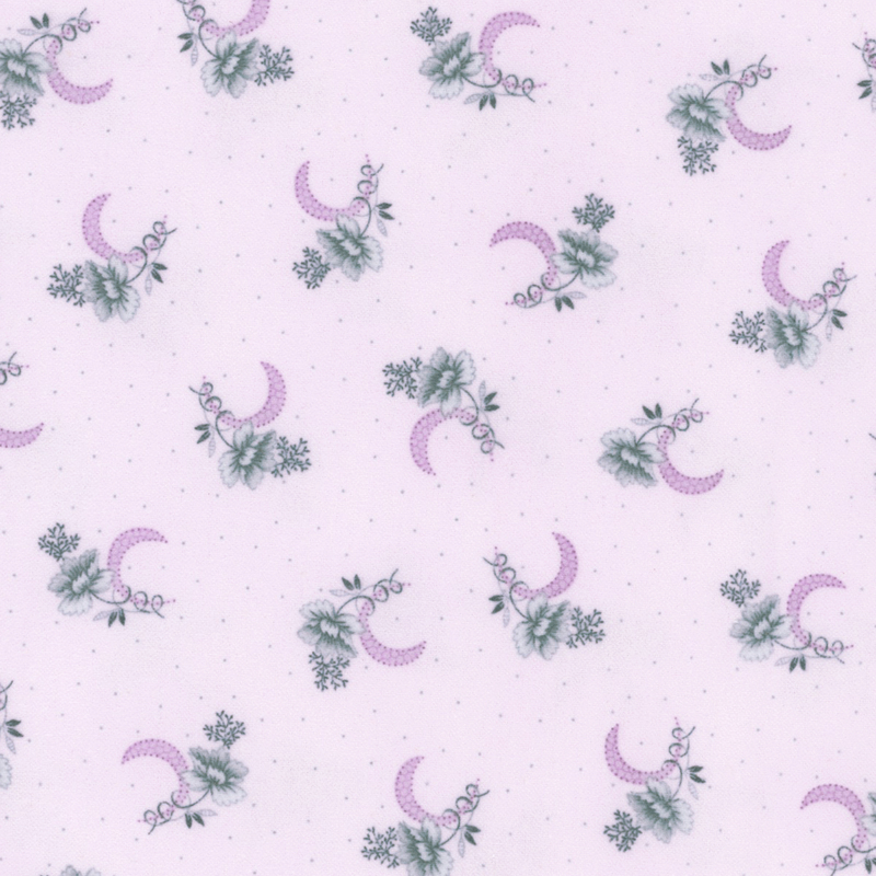 flannel fabric featuring scattered dusty blue flower clusters with dark purple crescent moons on a light purple background