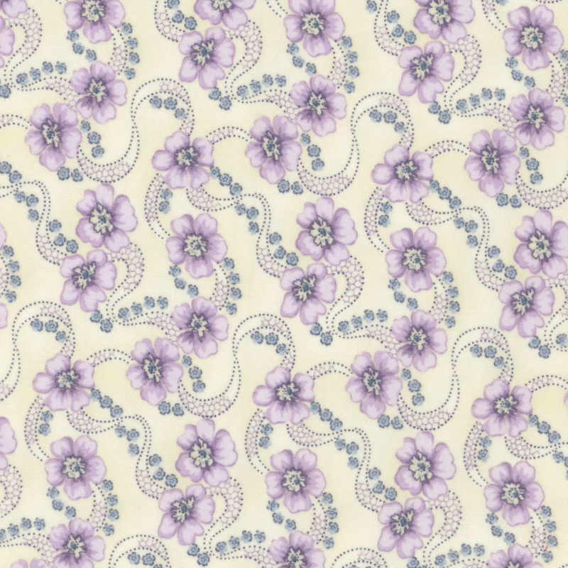 flannel fabric featuring light purple blooms with strings of small blue flowers on a light cream background