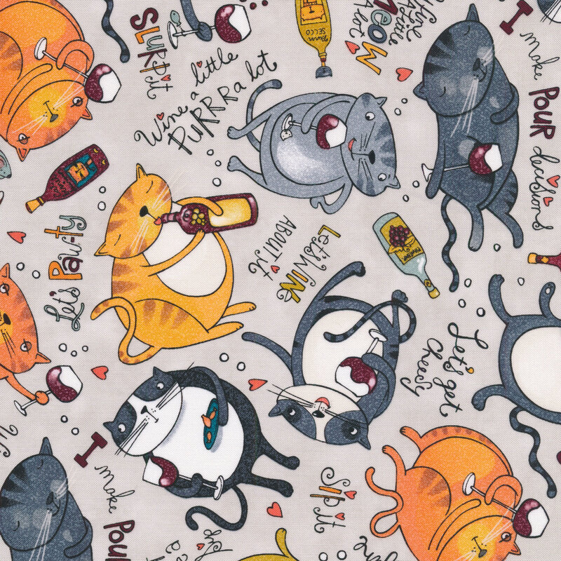 This fabric features cats with wine glasses and wine-themed slogans on a light gray background.