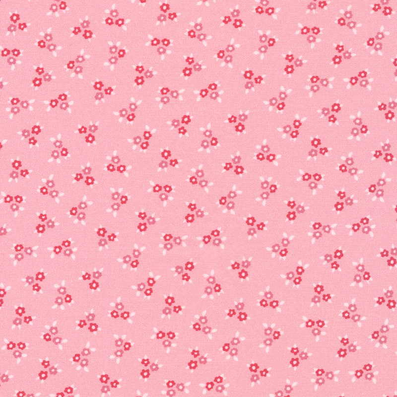 This fabric features ditsy clusters of flowers in tonal pinks on a pink background.
