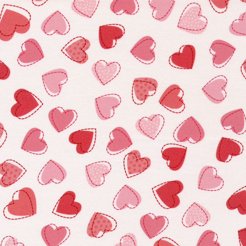 This fabric features pink and red tonal hearts on a solid white background.