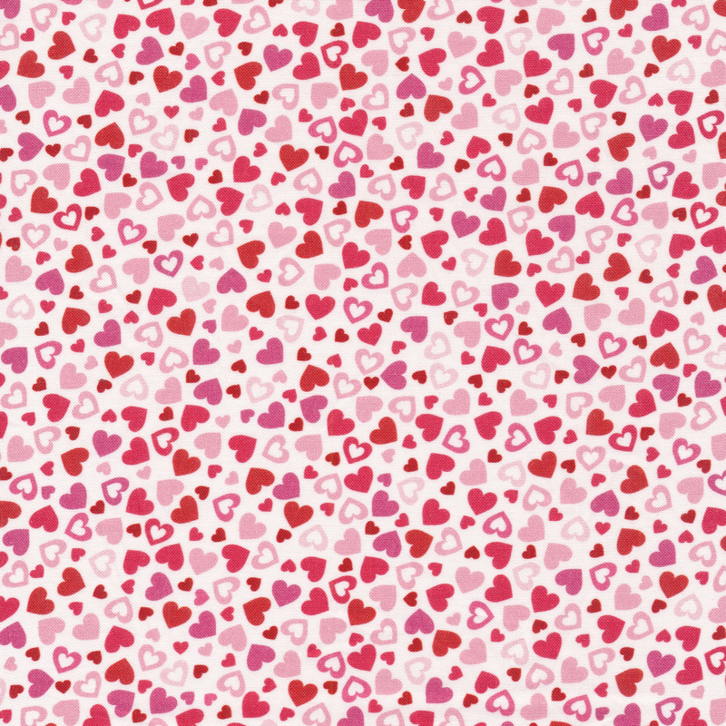 This fabric features pink and red tonal hearts tossed on a white background.