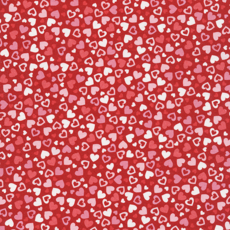 This fabric features pink and red tonal hearts tossed on a red background.