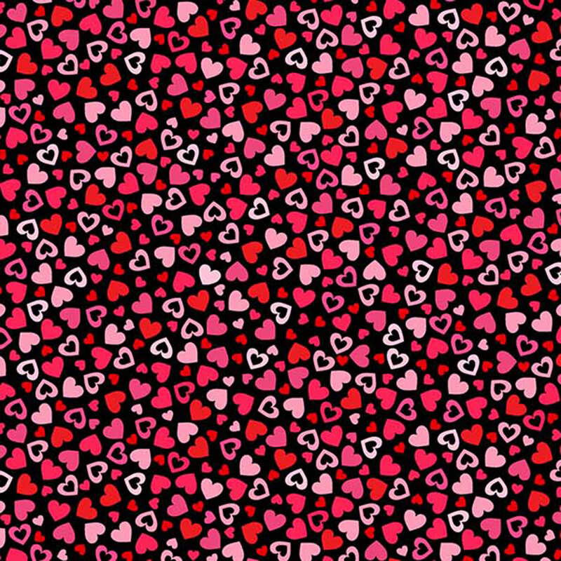 This fabric features pink and red tonal hearts tossed on a black background.