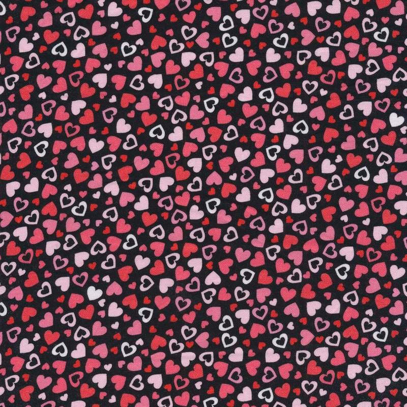 This fabric features pink and red tonal hearts tossed on a black background.