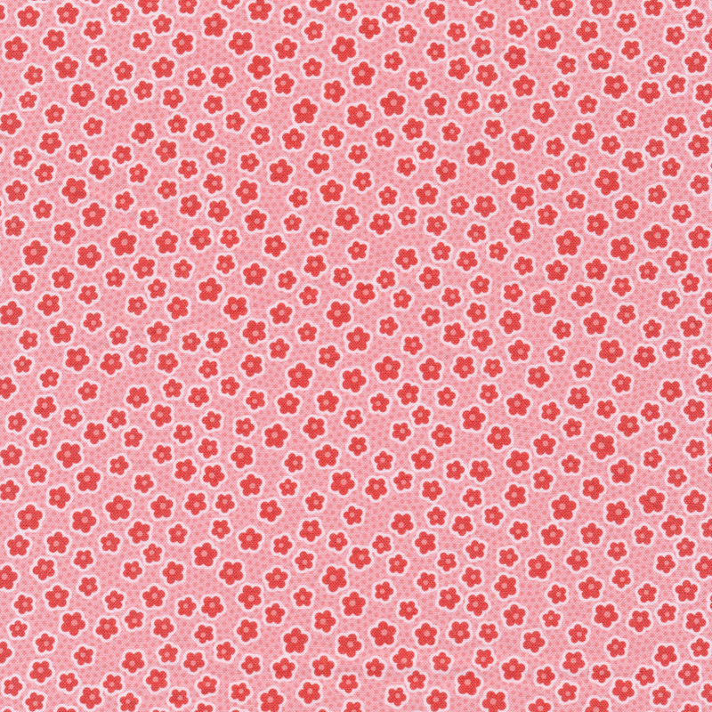 This fabric features tossed pink floral blossoms on a spotted pink background.