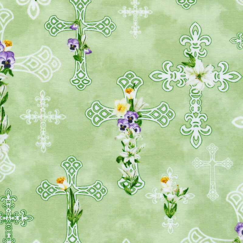This fabric features white crosses with white, yellow and purple florals on a light green background.