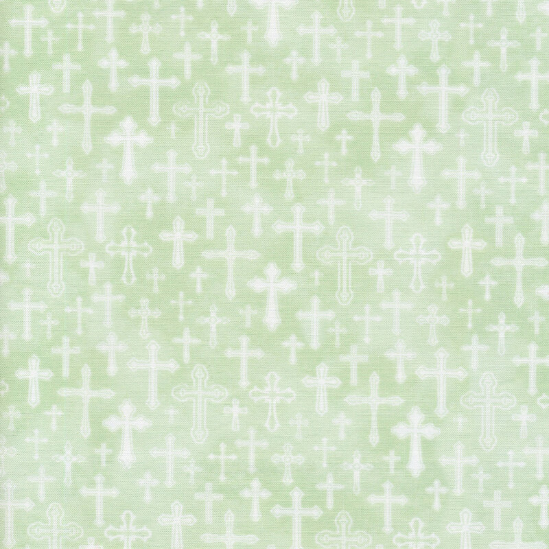 fabric featuring white crosses with a light green mottled background