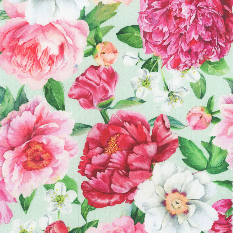 A pastel green fabric covered in large light and dark pink roses and florals.