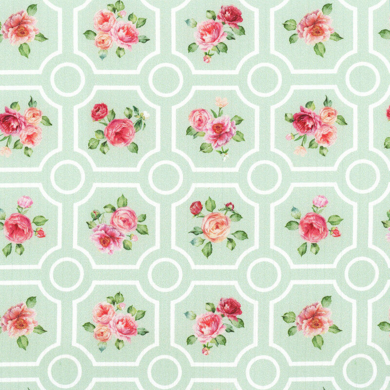 A pastel green fabric with tiled geometric outlines and roses