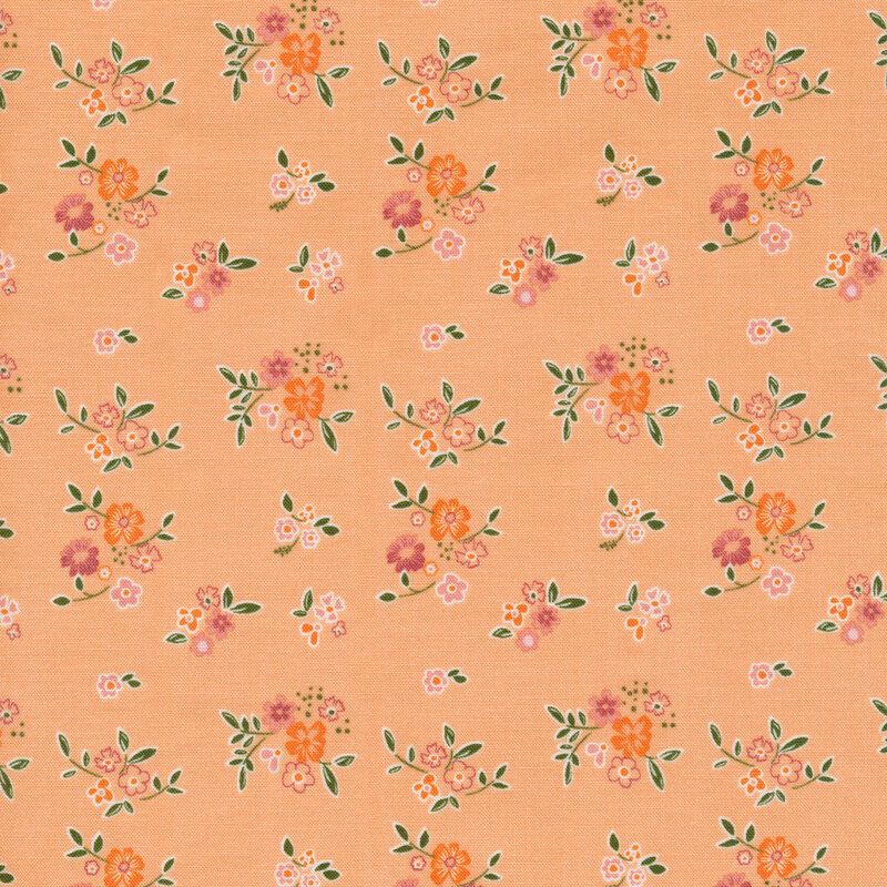 apricot orange colored fabric with scattered clusters of flowers and leaves scattered across it