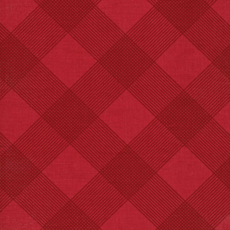 This fabric features a dark red plaid print on a solid red background