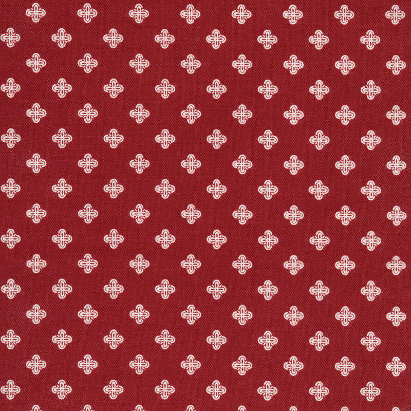 This fabric features dark red fabric with geometric white motifs.