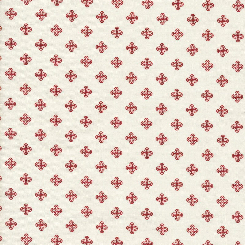 this fabric features solid cream background fabric with geometric red motifs