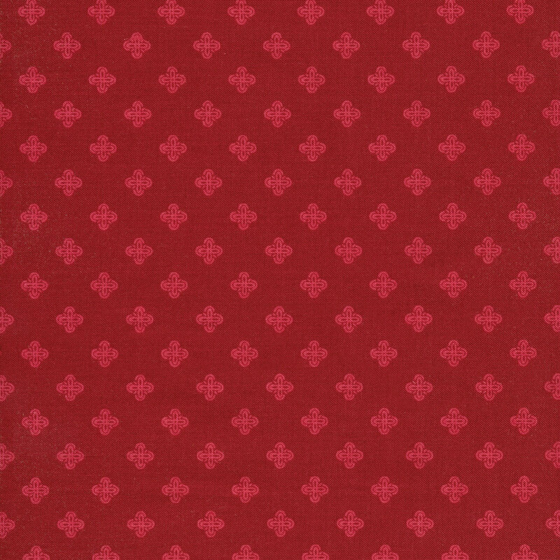 This fabric features dark red fabric with geometric bright red motifs.